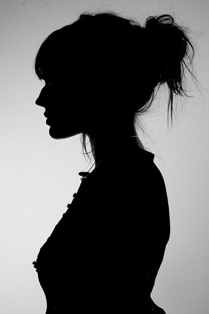 the silhouette of a woman is shown in black and white