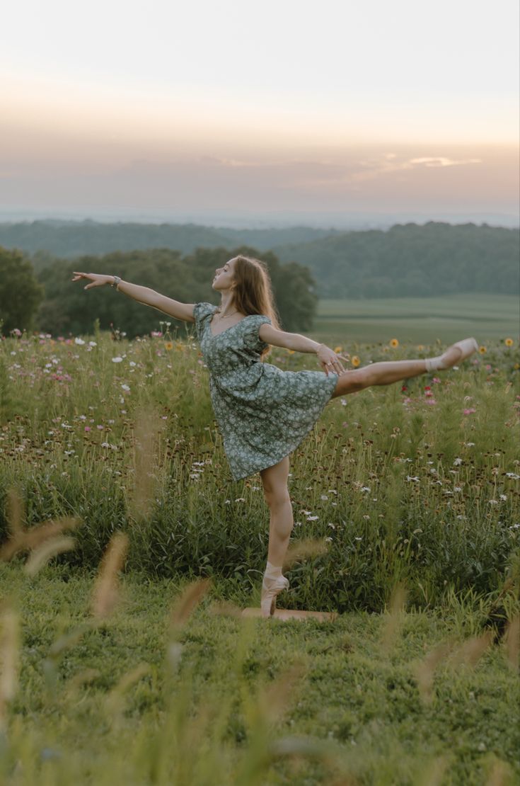 a woman in a field with her arms outstretched