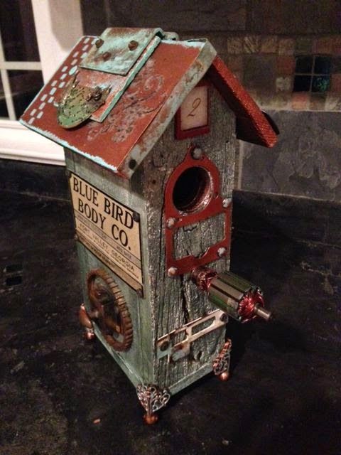 an old birdhouse with rusted metal parts on it's roof and door