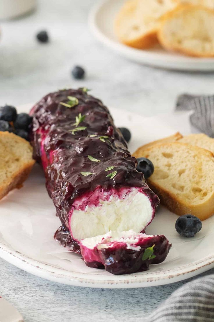 a plate with bread and blueberries on it