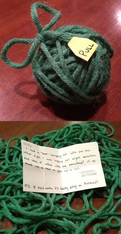 there is a ball of yarn on the table next to a piece of paper with a note attached