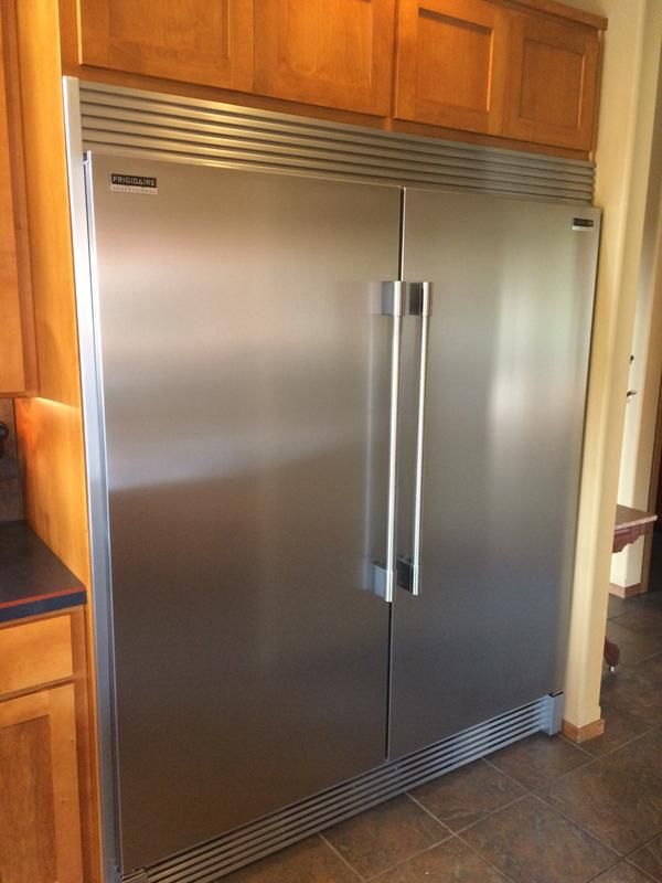 a stainless steel double door refrigerator in a kitchen