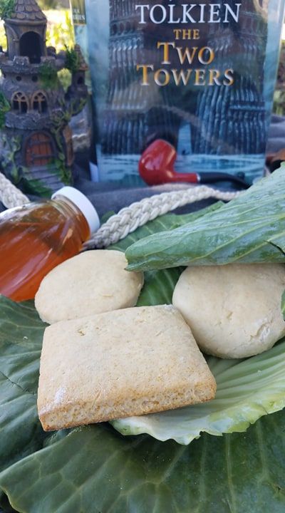 some food that is on top of a leafy green plate with a book in the background