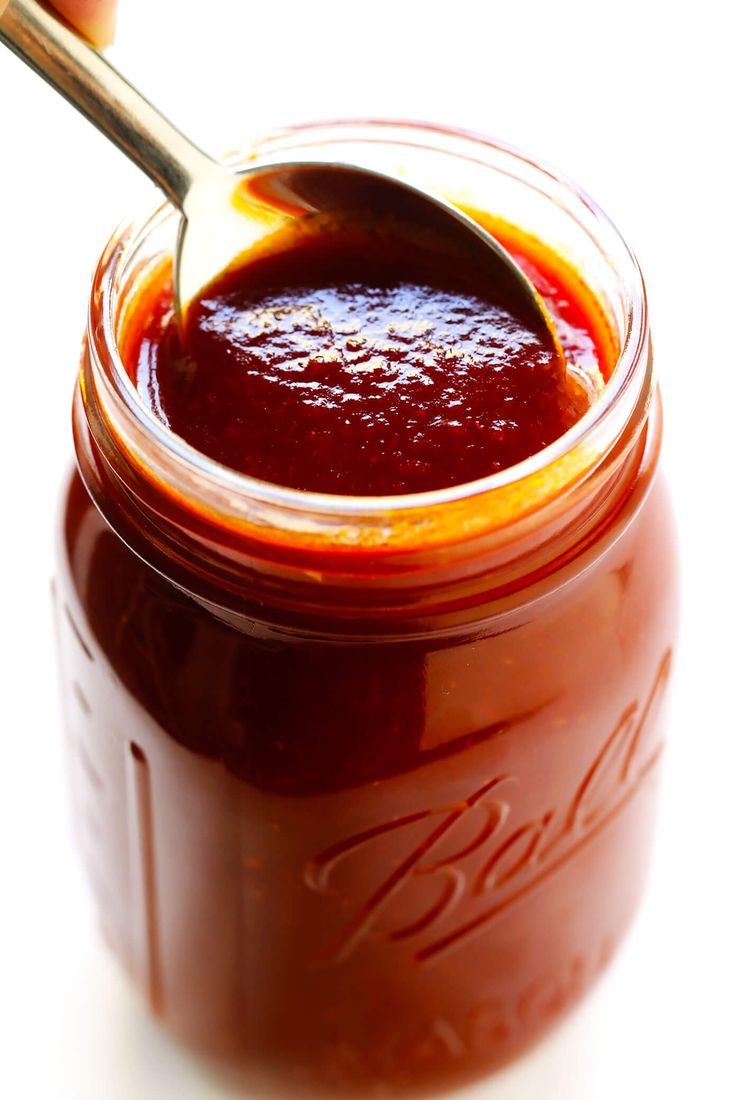 a spoon in a jar filled with sauce