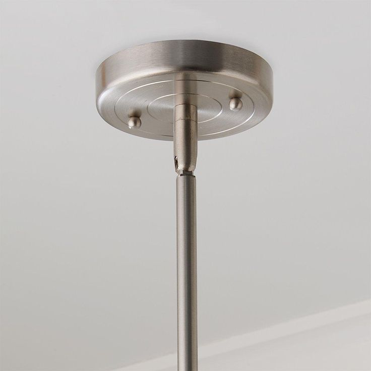 a close up of a light fixture in a room with white walls and flooring