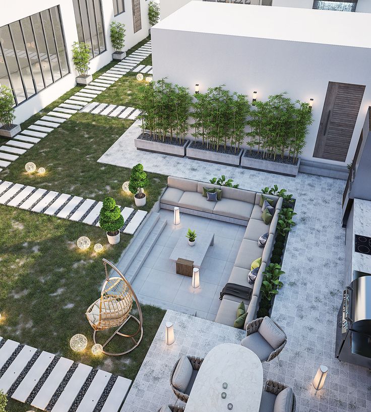 an aerial view of a courtyard with seating and trees in the background, at night