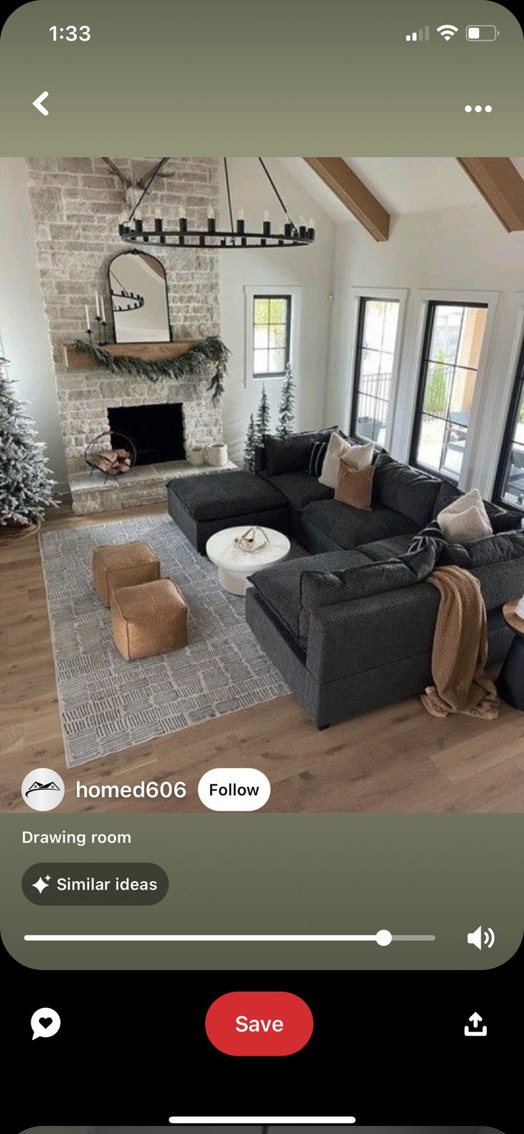 a living room filled with furniture and a fire place in front of a christmas tree