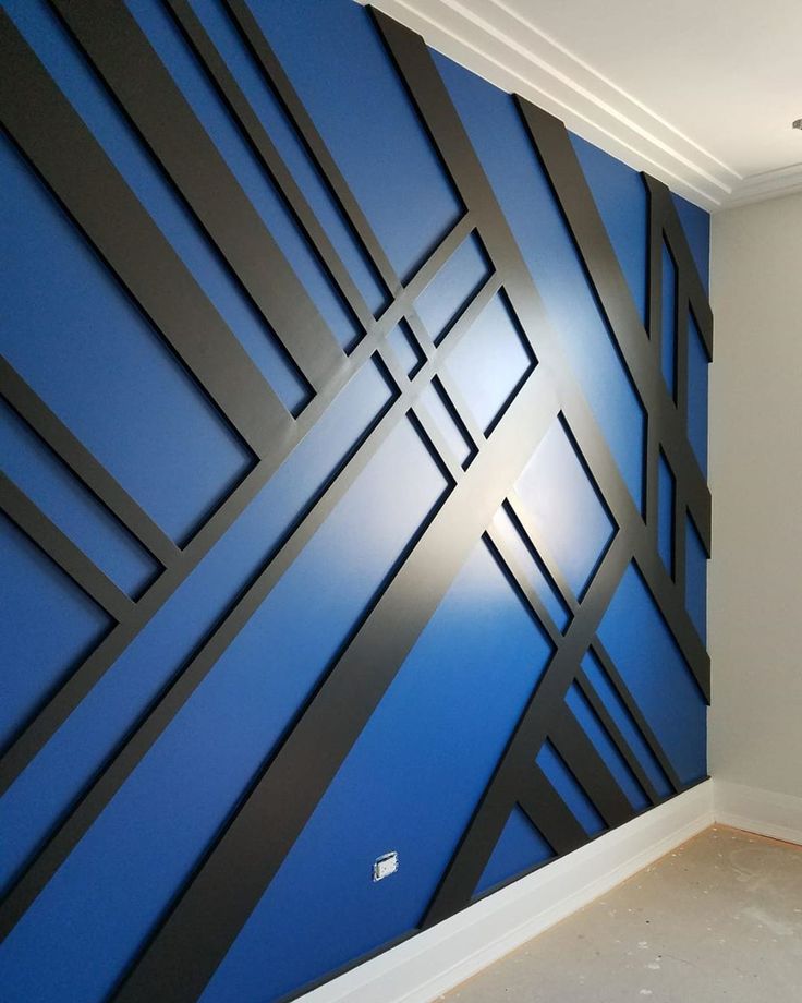 an empty room with blue and black wallpaper