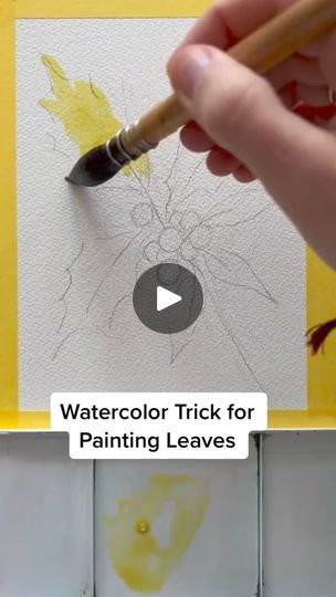 a person holding a paintbrush in front of a piece of paper with the words watercolor trick for painting leaves on it