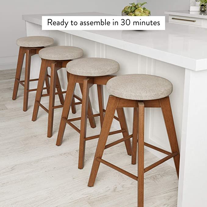 three stools sitting on top of a white counter