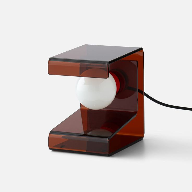 a red and black table lamp with a white ball on the end, attached to a cord