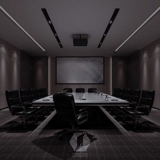 an empty conference room with black chairs and a large screen