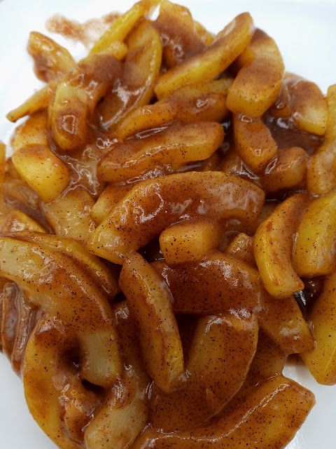 some fried food on a white plate with brown gravy and sauce over it