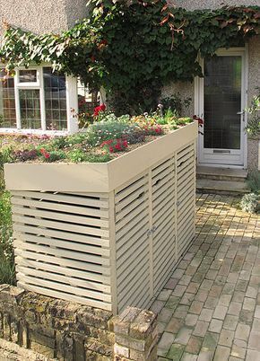 an outside view of a house with flowers and plants