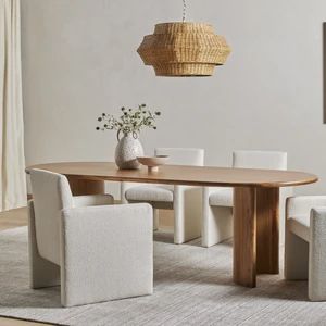 a dining room table with white chairs around it