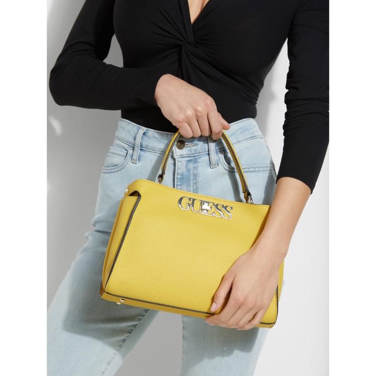 New With Tags Color:Yellow Textured Faux-Leather Satchel Featuring A Logo Emblem With Turnlock Security. Designed With A Divided Interior And Top Handle. Top Handle With 5" Drop. Detachable, Adjustable Crossbody Strap With 23" Drop. 11.5"W X 8"H X 4"D Style: #14017497 Bling Purses, Latest Handbags, Yellow Textures, Pink Shoulder Bag, Guess Purses, Yellow Handbag, Perfect Handbag, Quilted Handbags, Logo Emblem