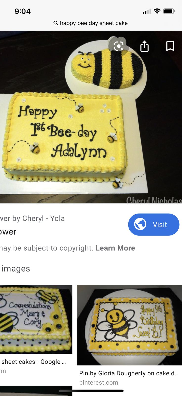 the cake is decorated with yellow and black frosting, and has a bee on it