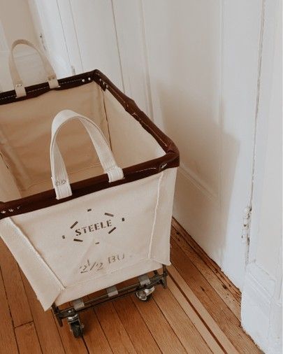 a brown and white bag sitting on top of a wooden floor next to a door