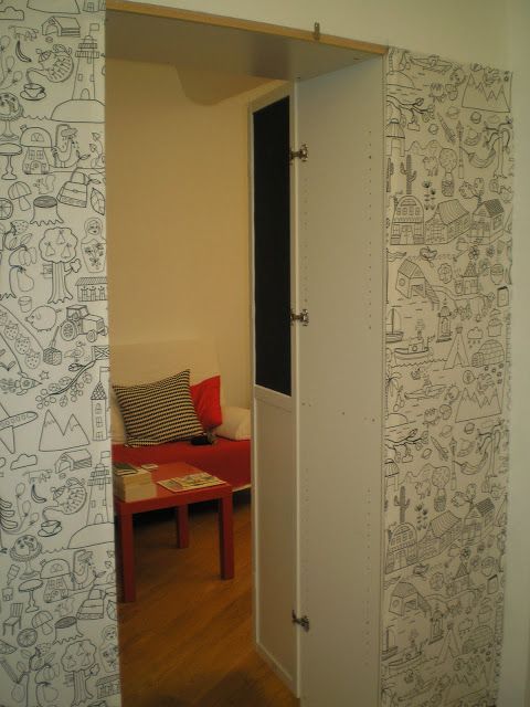 an open door leading into a living room with cartoon wallpaper on the walls and floor