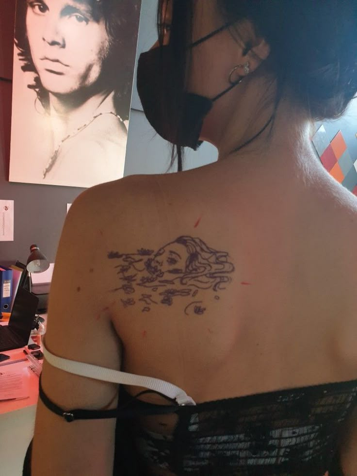 a woman with a tattoo on her back