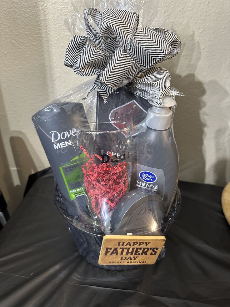 a father's day gift basket is displayed on a black tablecloth with a tag