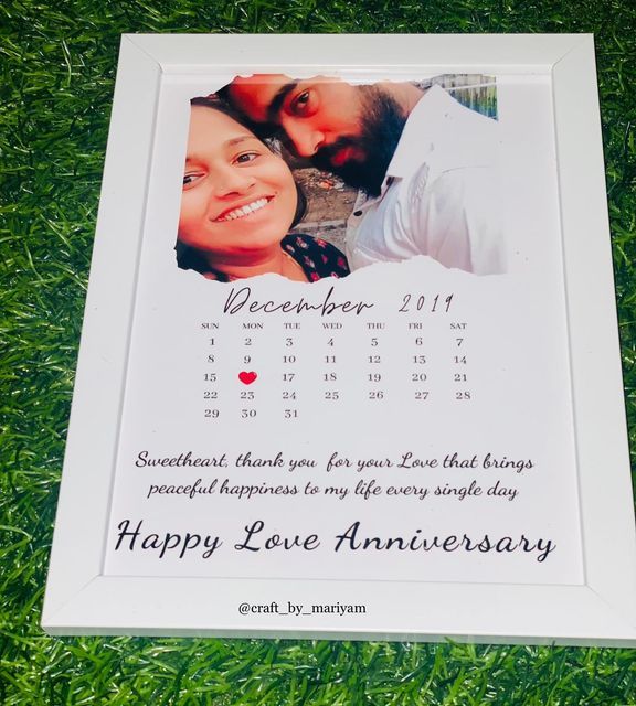 a white photo frame with a calendar on it and a happy love anniversary message in the middle