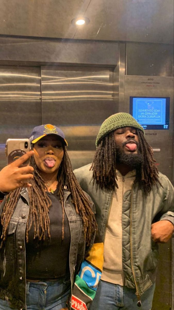 two people standing next to each other in an elevator