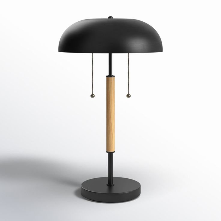 a black table lamp with a wooden stick on it's base and two lights attached to the top