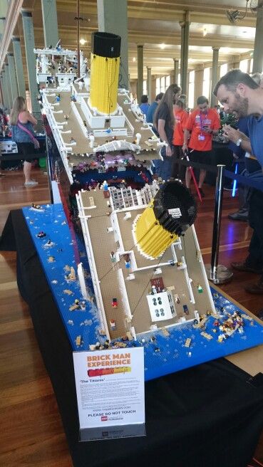 people looking at a model of a battleship