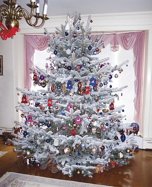 a white christmas tree with ornaments on it