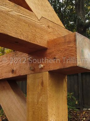 a close up of a wooden structure in the woods