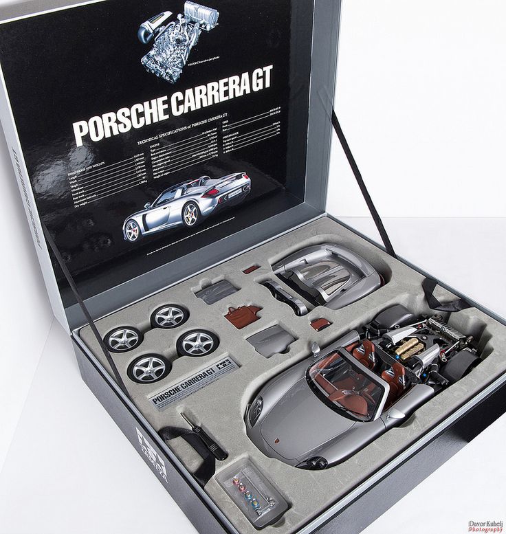 an open box containing a car model and accessories in the shape of a porsche carrerat