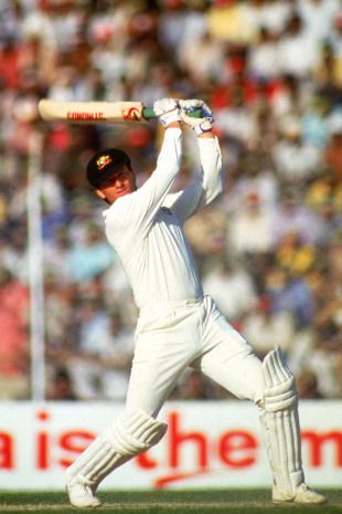 a man holding a baseball bat on top of a field in front of a crowd