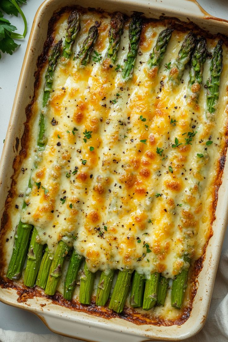 a casserole dish with asparagus and cheese