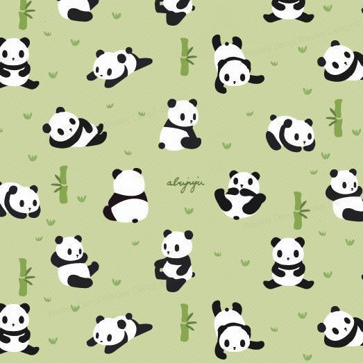 the pandas are laying down on the grass