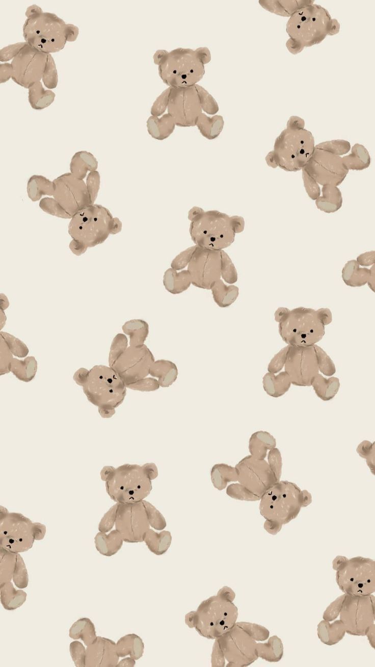 a group of teddy bears sitting next to each other on a white wallpaper background