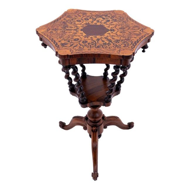 an antique wooden table with intricate carvings on it's top and bottom corner,