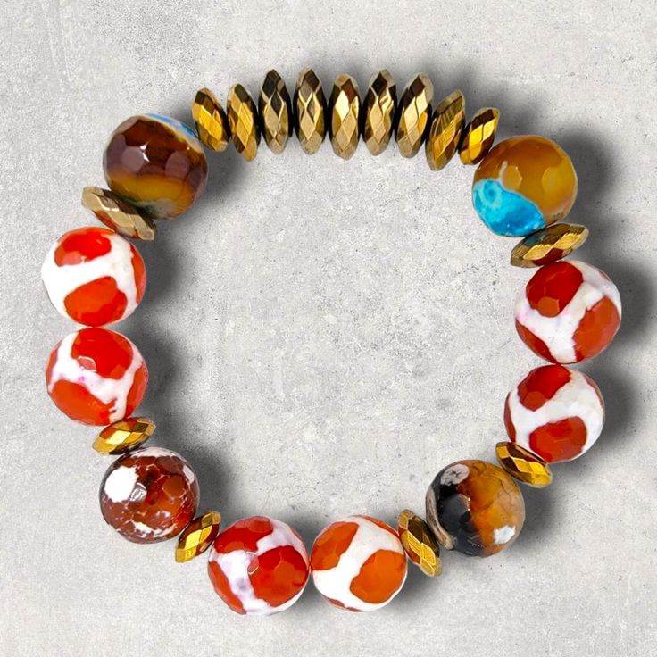 Materials used: Tibetan and fire agate beads and pale and antique gold hematite beads. Length: 7.5" Gold Beaded Bracelets With Large Czech Glass Beads, Unique Gold Beaded Bracelets With Faceted Beads, Agate Beaded Bracelets With Faceted Round Beads, Adjustable Carnelian Jewelry With Colorful Beads, Faceted Agate Beaded Bracelets, Faceted Agate Beaded Bracelets With Round Beads, Eclectic Beaded Bracelets With Natural Stones, Bohemian Agate Beaded Bracelets With Faceted Beads, Bohemian Beaded Bracelets With Faceted Agate Beads