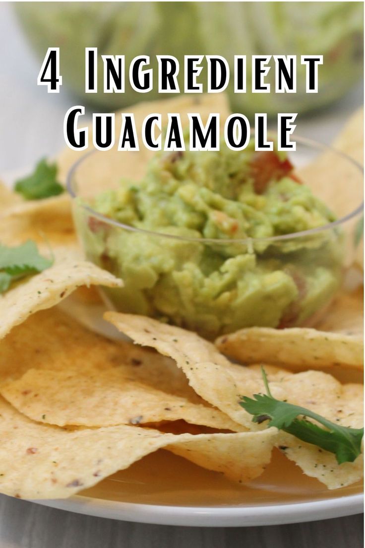 guacamole in a glass bowl with tortilla chips on the side