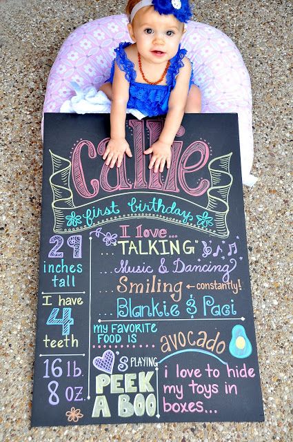 a baby sitting on top of a chalkboard with the words cake written in it