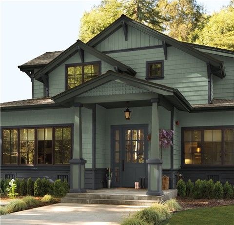 the front view of a gray house with lots of windows