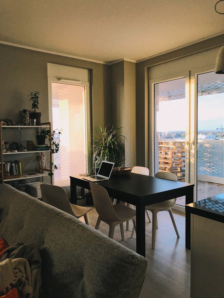 a living room filled with furniture next to a large sliding glass door that opens onto a balcony