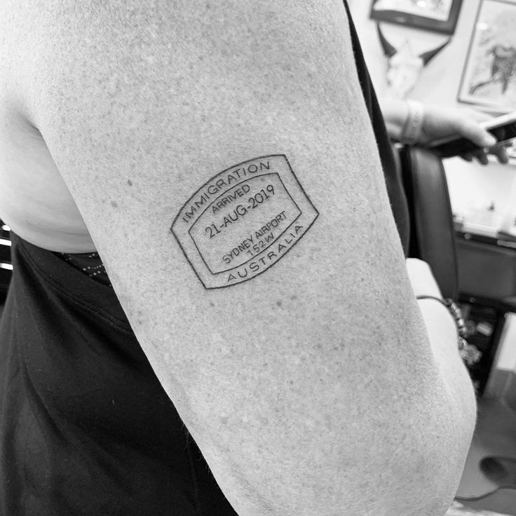 a black and white photo of a person's arm with a stamp on it