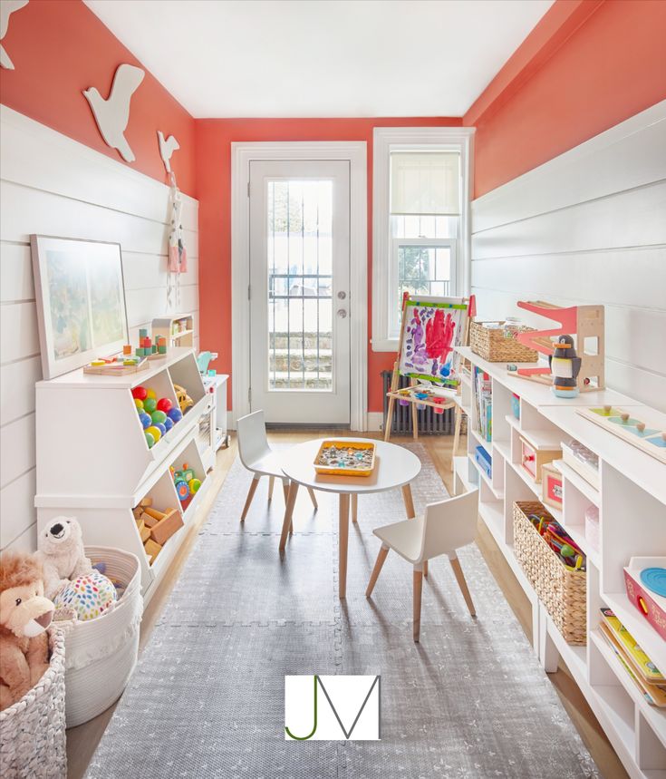 a child's playroom with toys and bookshelves