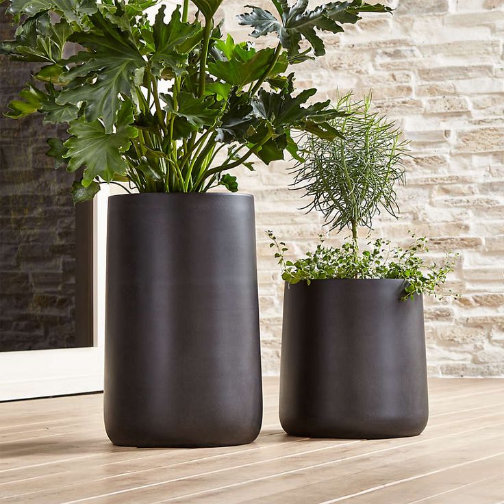 two planters sitting on top of a wooden table