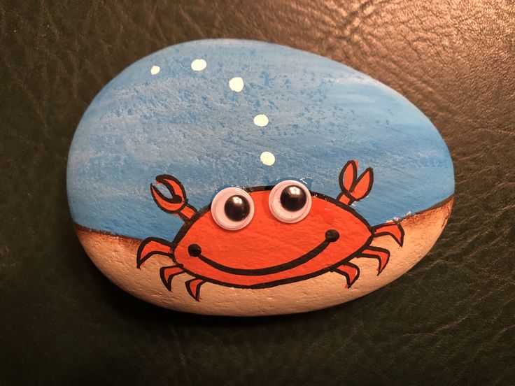 a painted rock with a crab on it