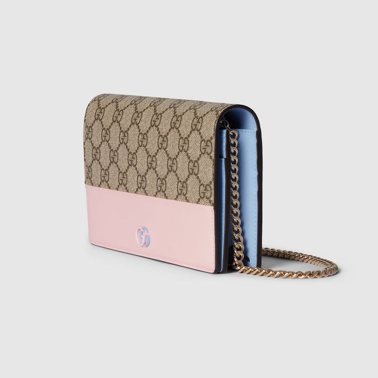 "Find GUCCI Gg Marmont Chain Wallet Leather on Editorialist. The House's most emblematic motifs are portrayed as timeless yet ever-evolving symbols throughout the latest collection. Appearing in a two-toned version, the iconic Double G logo defines this chain wallet, presented in both beige and ebony GG Supreme canvas and a light pink leather. Beige and ebony GG Supreme canvas, Light pink leather, Brass hardware with light pink and light blue ceramic-effect finishing, Moiré lining, Two-toned Double G, Inside: 6 card slots, 1 flat pocket, 1 zip pocket with gusset, 1 open compartment, Mirror, Chain strap, Snap button closure, Weight: 0.92lbs approximately, 7.8\"W x 5\"H x 1.6\"D, Made in Italy, Fits up to iPhone Plus, Airpods, and lipstick" Classic Gucci Wallet On Chain In Rectangular Shape, Gucci Classic Rectangular Wallet On Chain, Classic Rectangular Gucci Wallet On Chain, Gucci Rectangular Wallet On Chain With Chain Strap, Gucci Wallet On Chain With Rectangular Shape, Gucci Gold Rectangular Wallet On Chain, Gucci Gold Wallet On Chain For Everyday Use, Italy Fits, Double G Logo