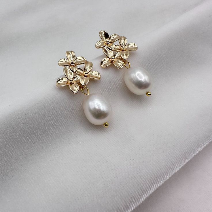 HIGH-LUSTER HANDPICKED WHITE FRESHWATER PEARL FLORAL EARRINGS FOR WOMEN - THE AAA QUALITY, GIA-CERTIFIED GENUINE PEARL EARRINGS YOU CAN TRUST!  -------------------------------------------------------- These floral pearl drop earrings feature AAAA quality dangling freshwater pearls and a beautiful 925 silver floral post, gold-plated with the finest 18K yellow gold. The pearls have a smooth, natural white surface that is glowing, and the gold is designed with a flower-like pattern that encases the Elegant Hypoallergenic Flower Jewelry, Elegant Hypoallergenic Flower-shaped Earrings, Elegant Hypoallergenic Flower Shaped Earrings, Formal Dangle Flower Earrings With Pearl Drop, Elegant Round Hypoallergenic Flower Earrings, Elegant Hypoallergenic Round Flower Earrings, Elegant Flower Shaped Hypoallergenic Earrings, Formal Pearl Drop Dangle Flower Earrings, Formal Pearl Drop Flower Dangle Earrings