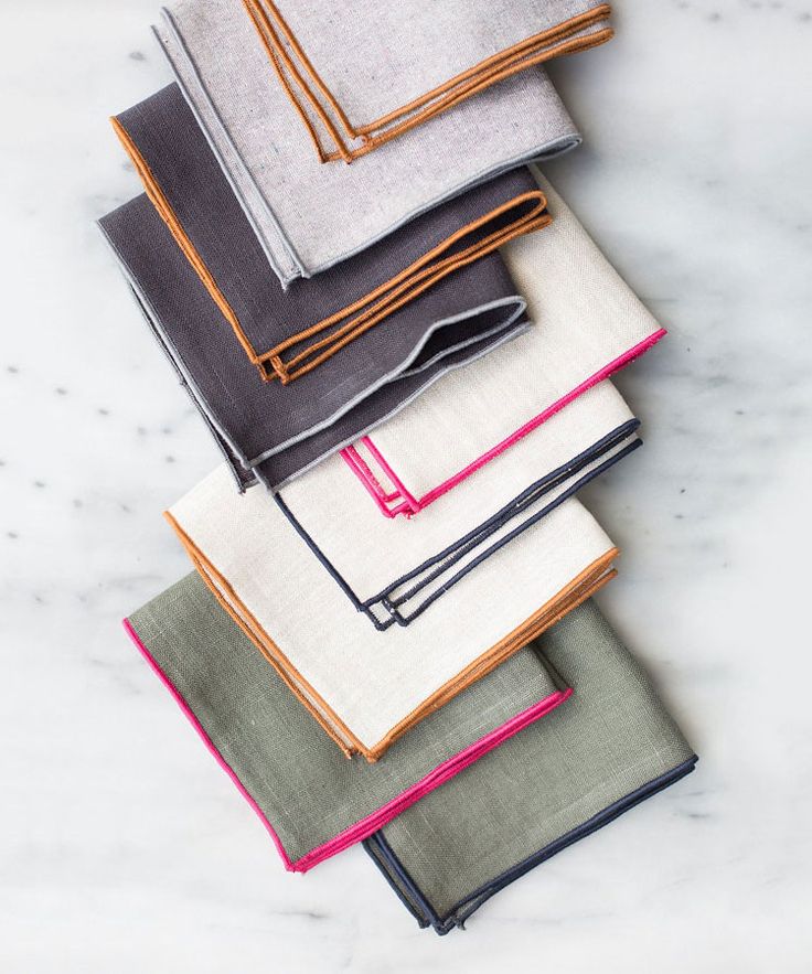 six folded napkins sitting on top of a white countertop next to each other