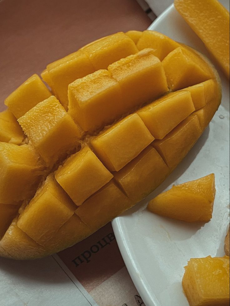 slices of mango sitting on top of a white plate